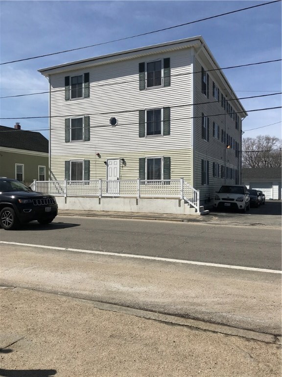 Front of building, north side parking and side of