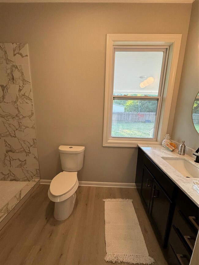 Bathroom featuring hardwood / wood-style floors, t