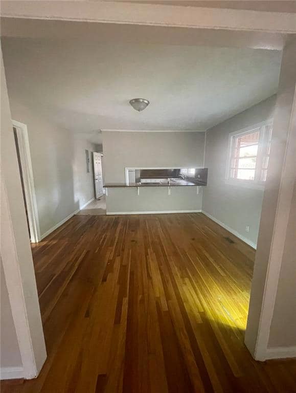 Unfurnished living room with hardwood / wood-style