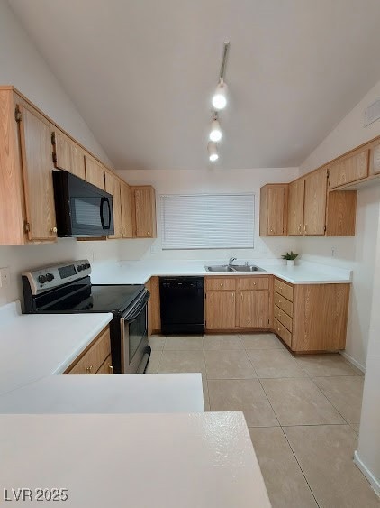 Kitchen featuring black appliances, a sink, lofted