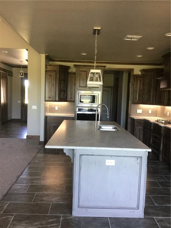 Stainless steel appliances and sink, gas cooktop