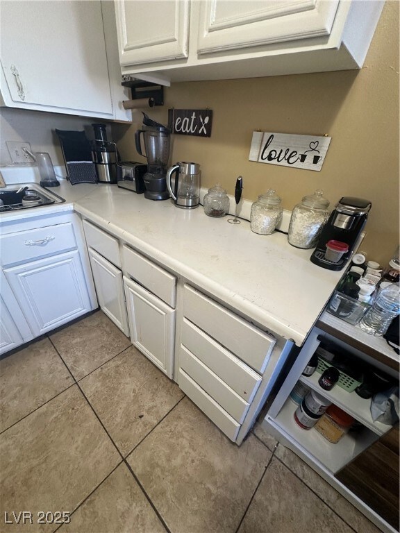 Unit A: Kitchen with white cabinetry, light counte