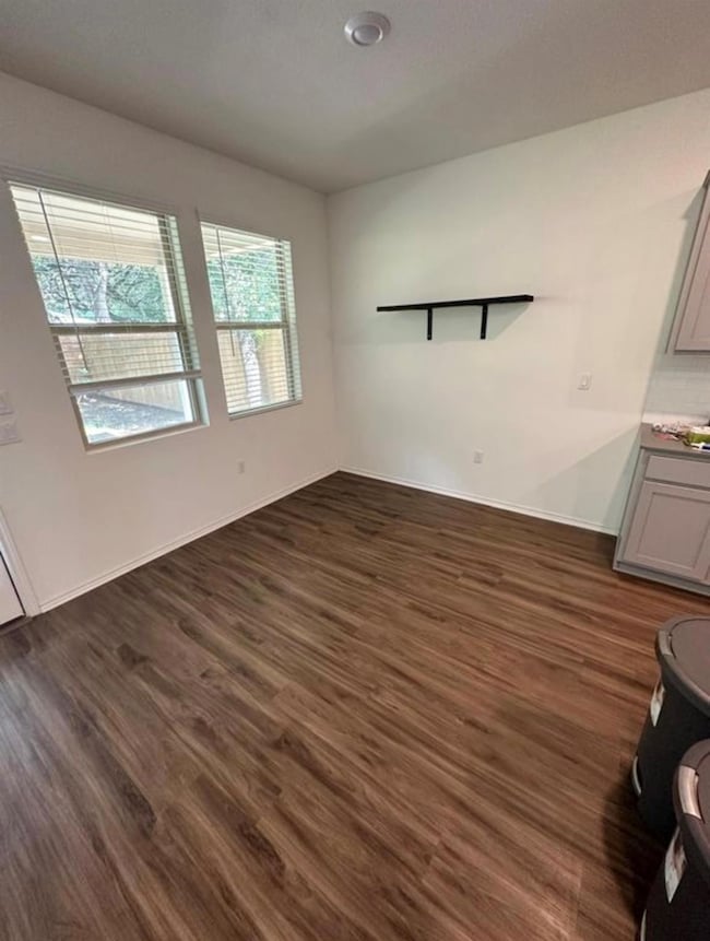 Unfurnished dining area featuring dark wood finis