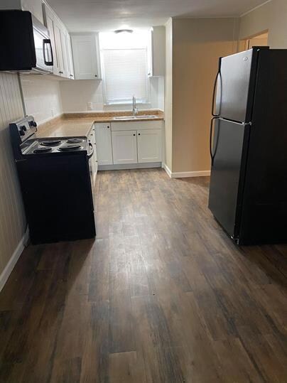 Kitchen featuring freestanding refrigerator, a si