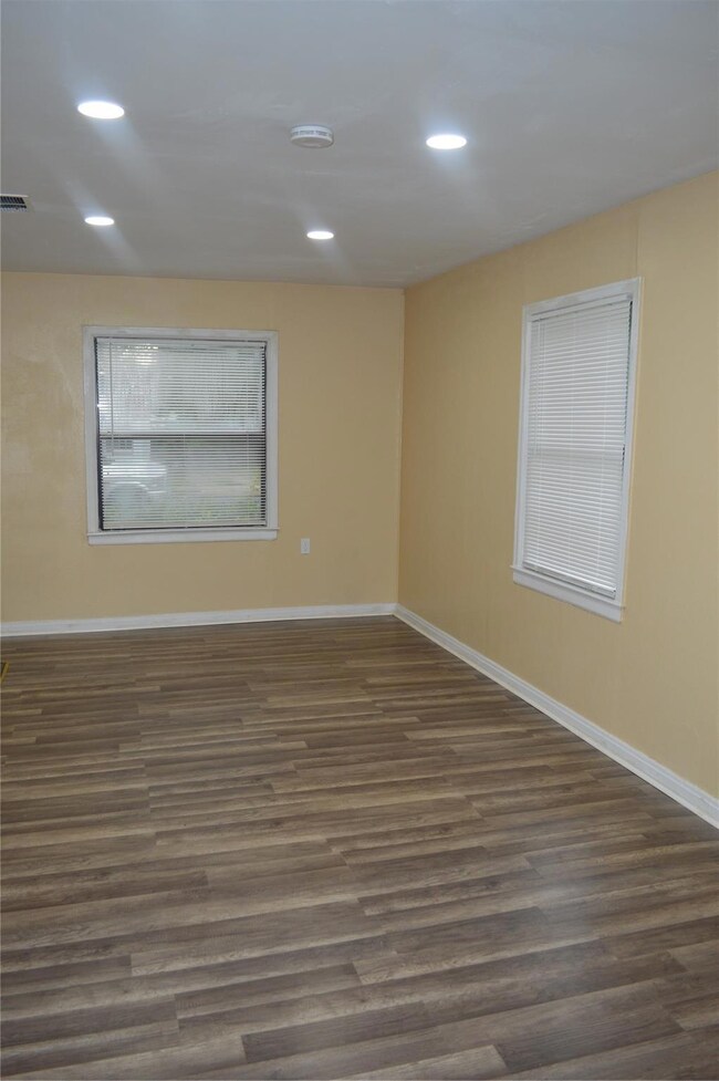 Empty room featuring dark wood-type flooring