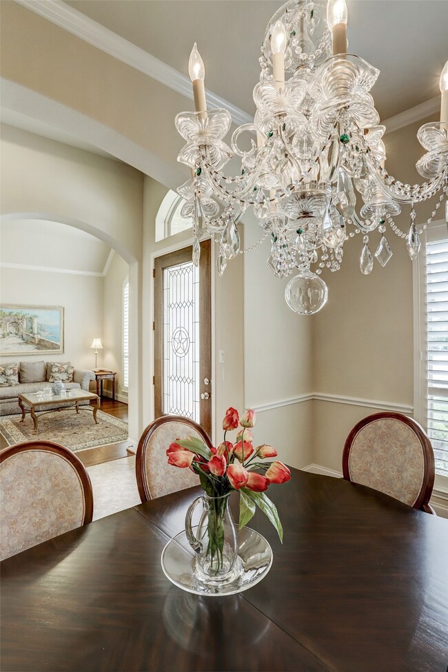  Hardwood floors and a custom crystal chandelier showcase this stunning room.