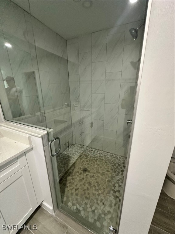 Bathroom featuring a stall shower and vanity