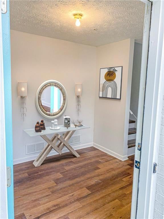 Hallway featuring wood finished floors, baseboards