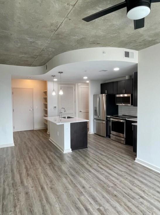 Kitchen featuring decorative backsplash, light woo