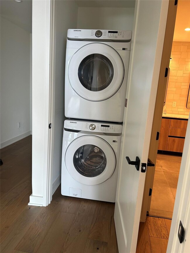 Laundry room with baseboards, laundry area, stack