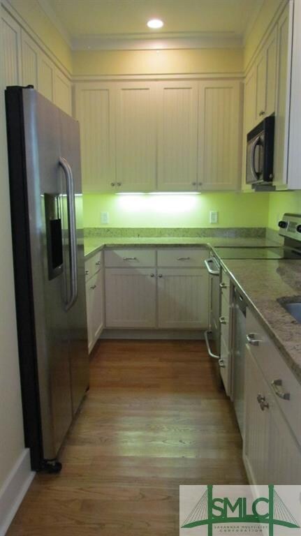Kitchen area includes, refrigerator, microwave, ov