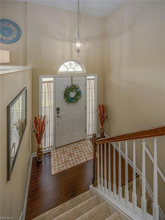 The two story foyer with hardwood floors.  Downsta