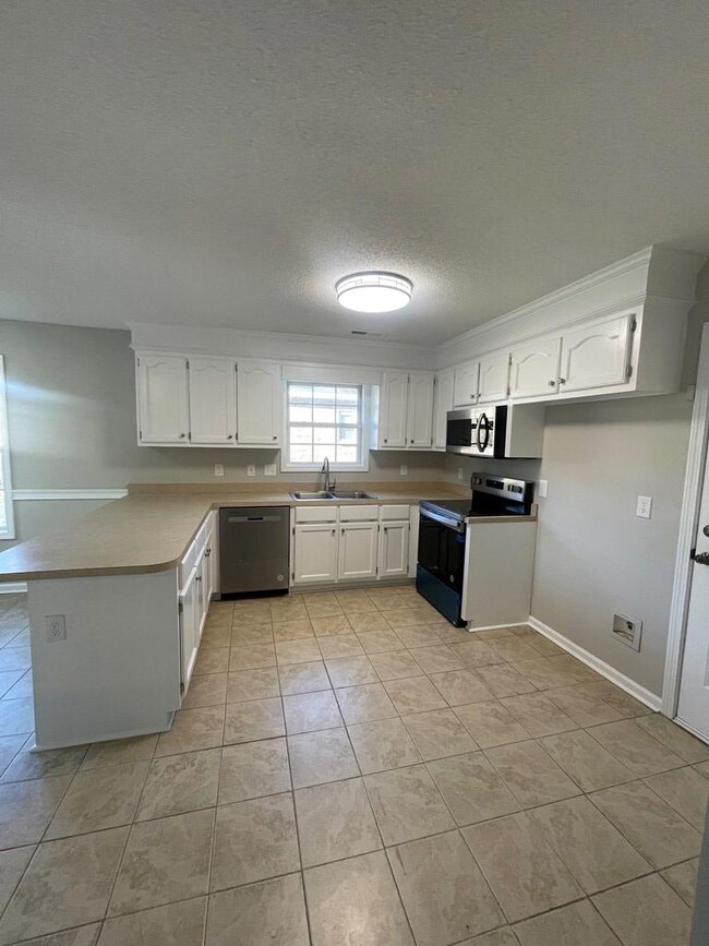 White kitchen with breakfast Bar and Eat-in Area