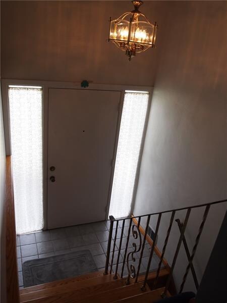 The foyer has ceramic tile floor, two side windows