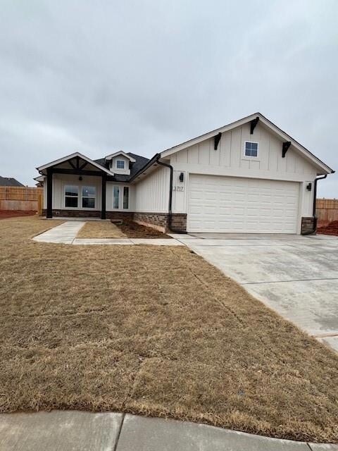 Single story home with a garage and a front yard