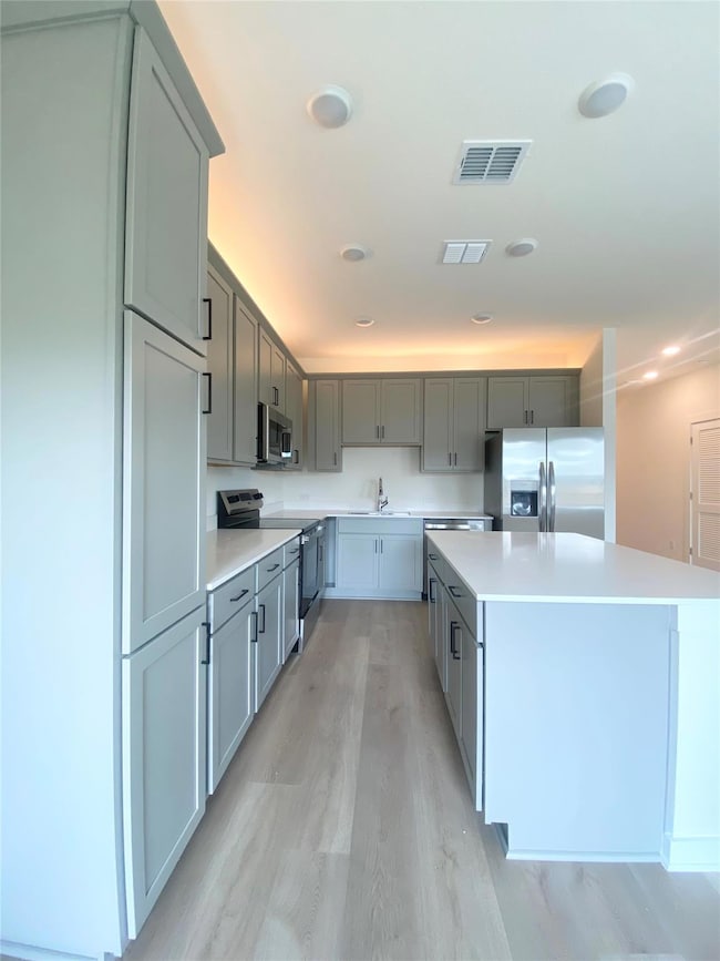 Kitchen featuring appliances with stainless steel