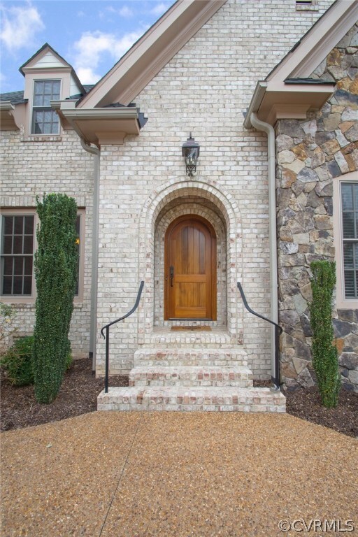 Brick steps lead to the covered vestibule of the f