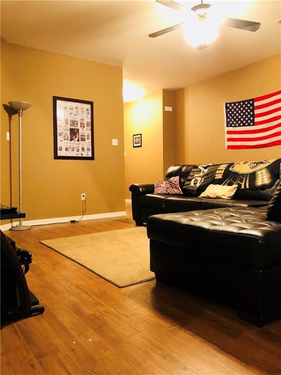 Large living room with high ceilings and ceiling f