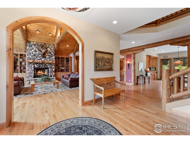 Entry to great room and breakfast dining room. Log and craftsmanship details throughout.