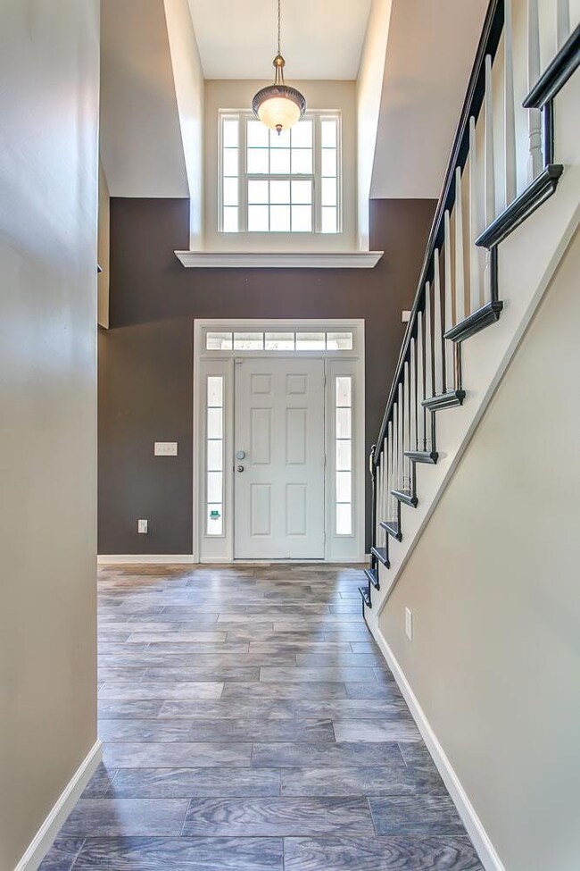 Two story entry with transom and side windows at the front door.