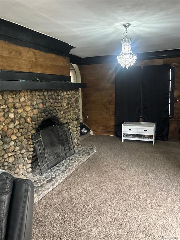 Unfurnished living room with carpet flooring, a stone fireplace, and wood walls