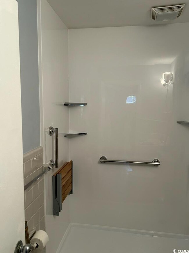 Bathroom featuring tile walls
