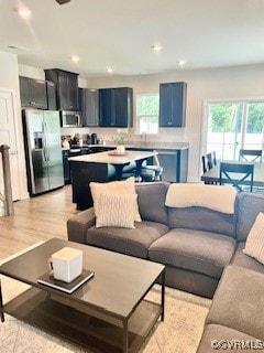 Living room with light wood-style flooring and rec