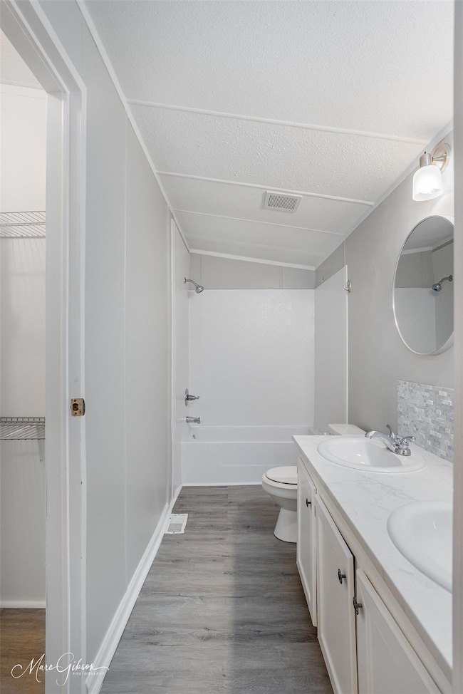 Full bathroom featuring vanity, wood-type flooring