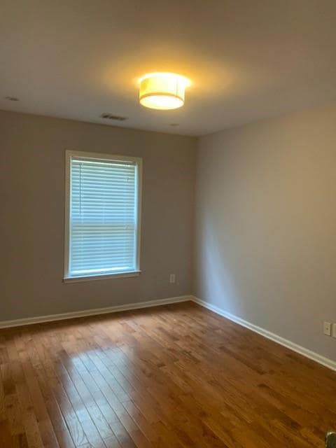 master bedroom featuring hardwood flooring
