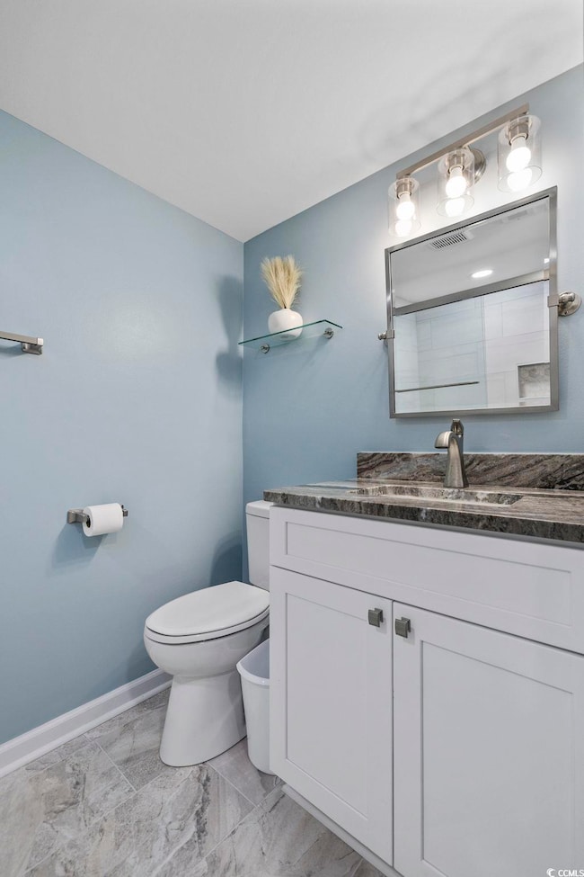 Bathroom featuring vanity and toilet