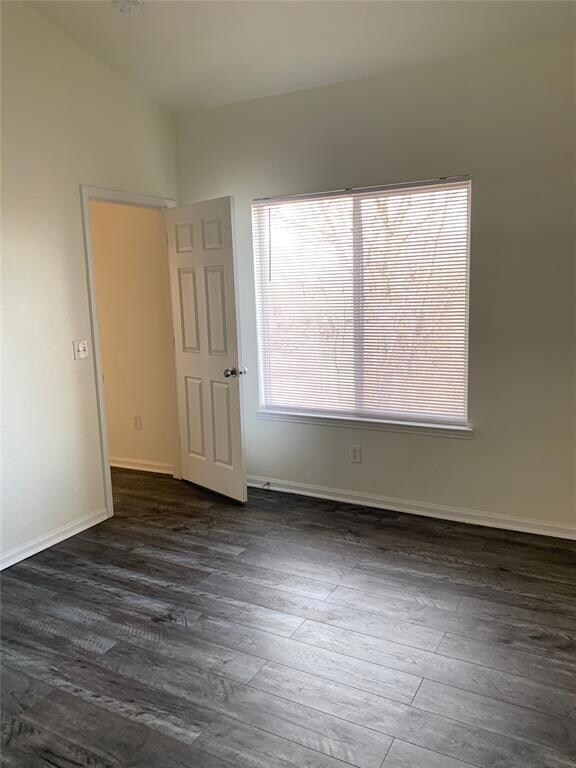 Spare room with dark hardwood / wood-style floors 