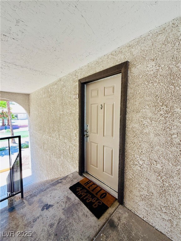 Property entrance with stucco siding