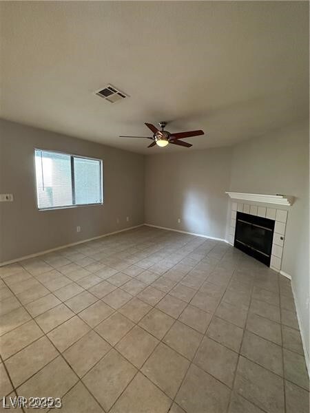 Unfurnished living room with baseboards, light til