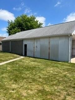Two car garage with carport and concrete driveway