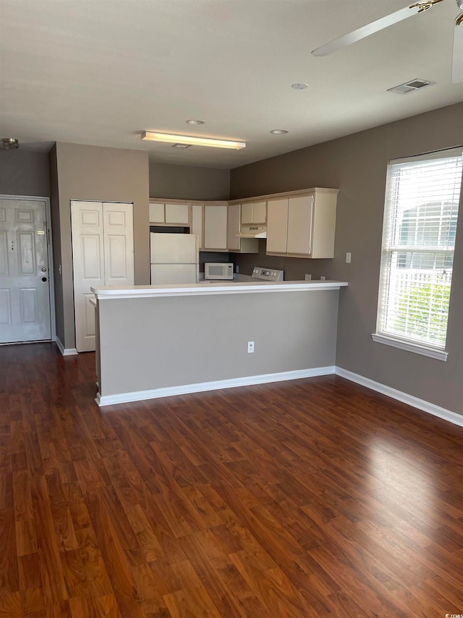 Kitchen featuring white appliances, white cabinetr