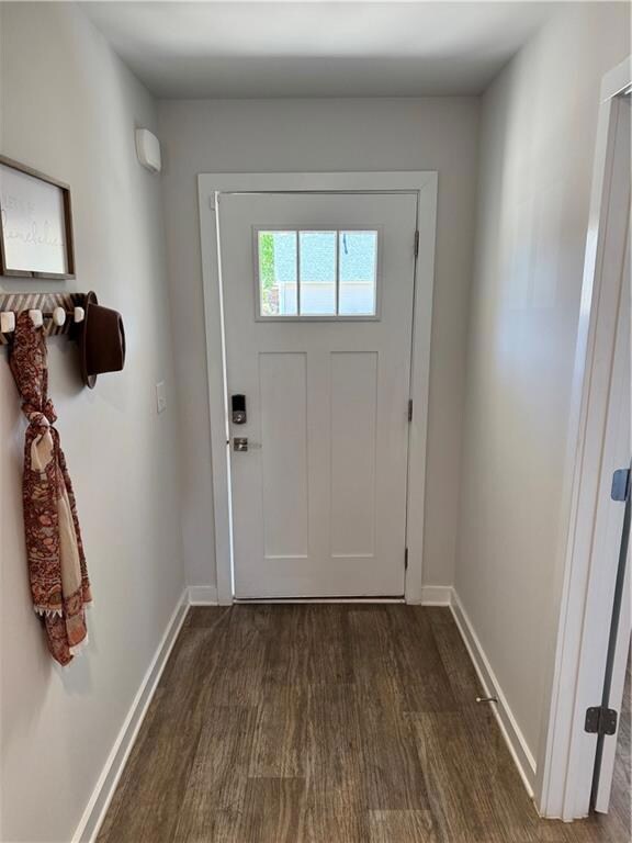 Doorway to outside featuring dark wood-type floori