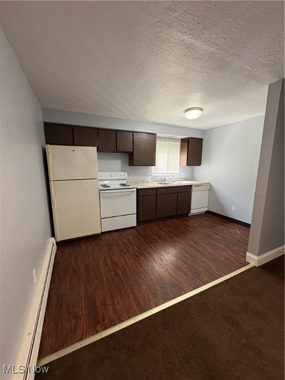 Kitchen featuring dark brown cabinets, fridge, white stove, light countertops, and a baseboard heating unit