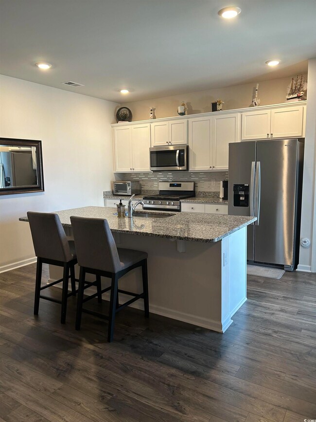 Kitchen featuring decorative backsplash, appliance