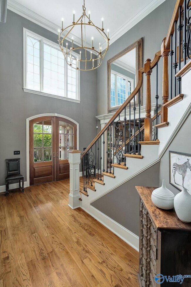 Imagine welcoming your guests from atop the artful wooden staircase in the two story foyer.