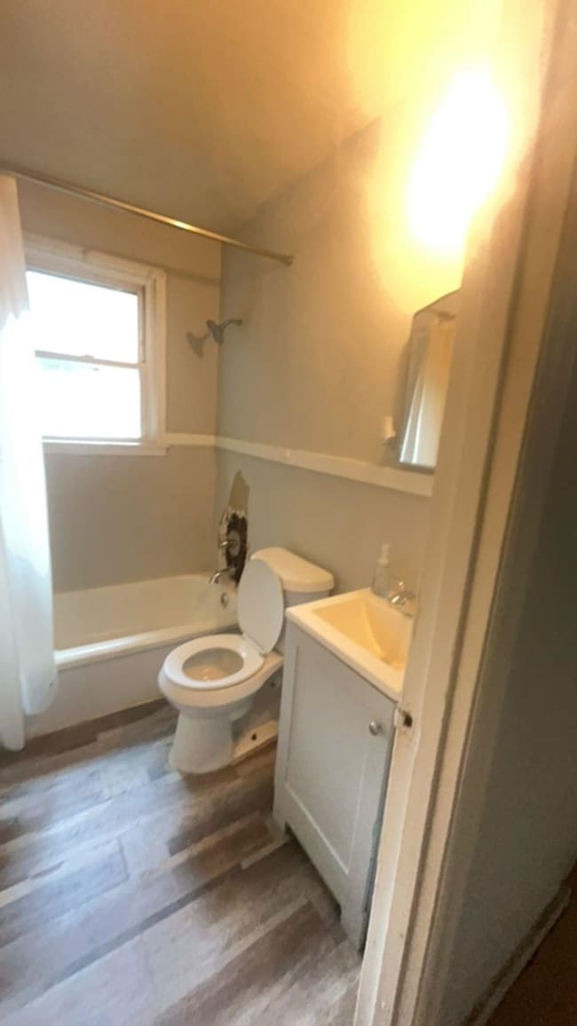 Full bathroom featuring vanity, toilet, and bathing tub / shower combination
