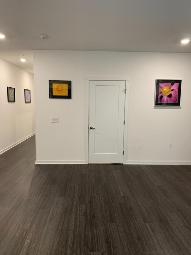 Unfurnished room with baseboards, dark wood-type 