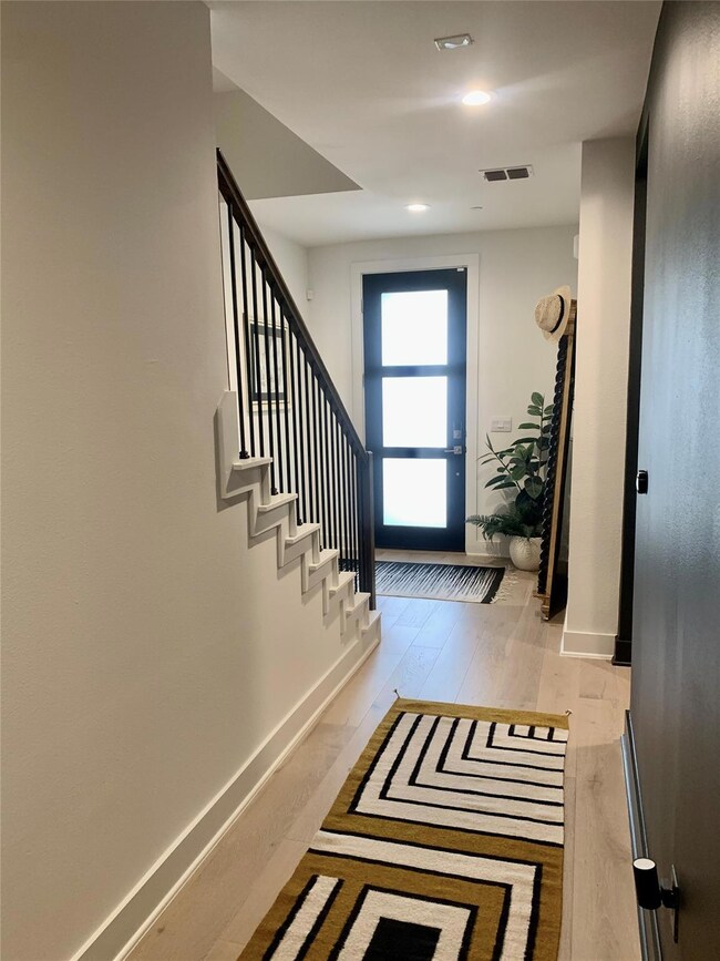 Entrance foyer featuring wood finished floors, re
