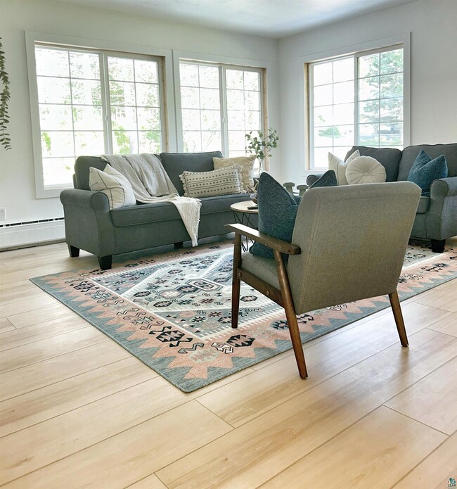 Living room with light hardwood / wood-style floor