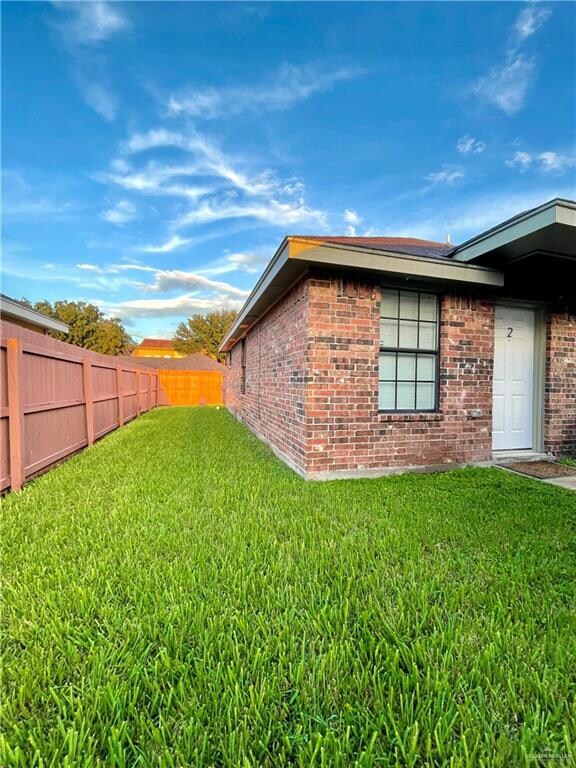 View of property exterior with a yard