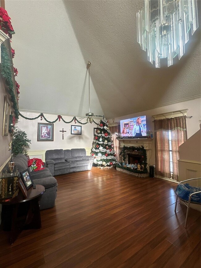 Living room featuring vaulted ceiling and wood-typ