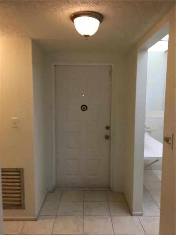 INSIDE FRONT DOOR ENTRANCE LOOKING INTO LIVING ROOM