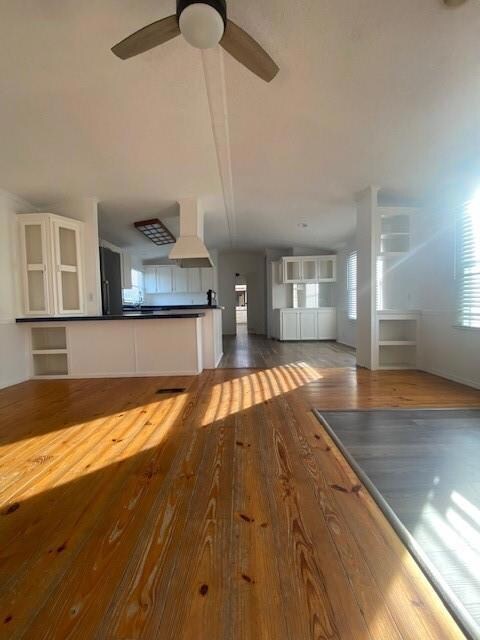 Bathroom with vanity, toilet, a bathing tub, and hardwood / wood-style floors