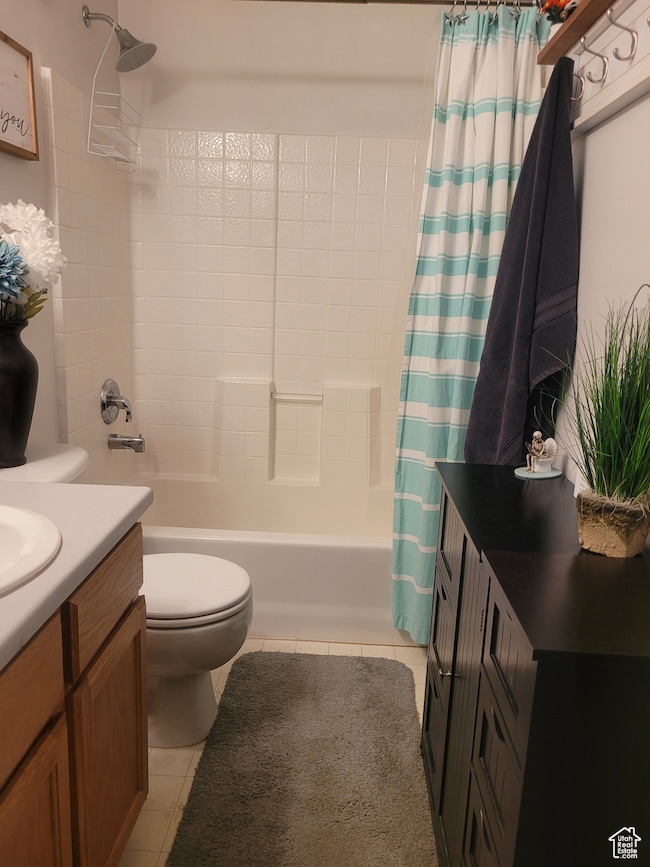 Bathroom with vanity, shower / bath combo, and light tile patterned floors