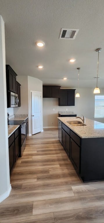 Kitchen featuring sink, light hardwood / wood-styl