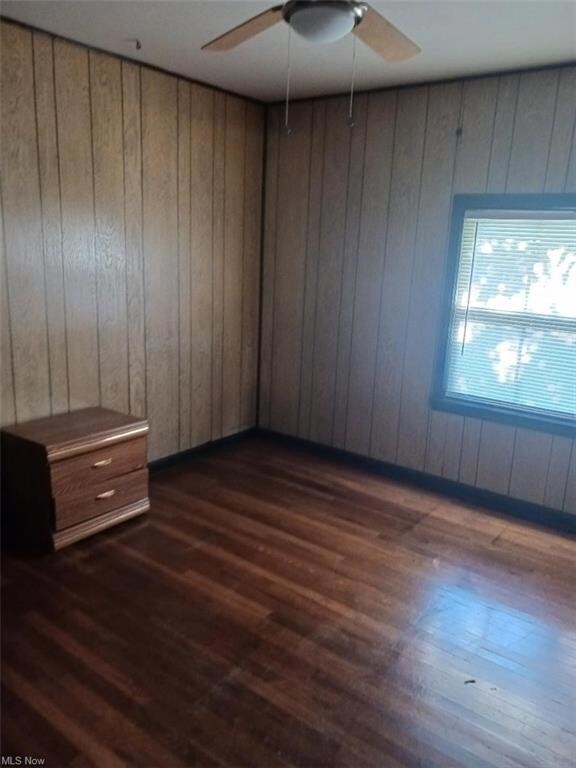 Wood floored empty room with ceiling fan